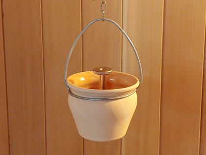 84988: Ceramic Aroma Dispenser hangs from chain above Sauna heater